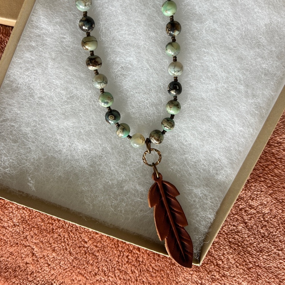 Elegant Beaded Necklace with Leather Feather Pendant